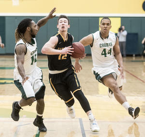 Holly Hart/The News-Gazette  Danville's Cayman Meier (middle) drives between Parkland defenders De'Quantis Jackson (#10) and Jessy Cantinol (#44) in the first half. Parkland College Men's Basketball vs Danville Area Community College, Saturday, February 27, 2016 at Parkland College.