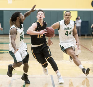 Holly Hart/The News-Gazette Danville's Cayman Meier (middle) drives between Parkland defenders De'Quantis Jackson (#10) and Jessy Cantinol (#44) in the first half. Parkland College Men's Basketball vs Danville Area Community College, Saturday, February 27, 2016 at Parkland College.